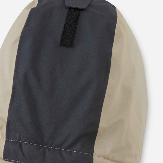 Combinaison de ski Reima Skaulo ReimaTec pour enfants, couleur « Earthy Beige » – détail au niveau des genoux
