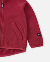 Veste polaire Reima Hopper pour enfants, couleur Cranberry : vue détaillée de la poche et des manches